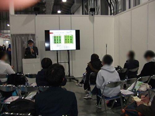 ドローン水稲モニタリングとAIによるモニタリングデータ解析について説明を聞く来場者の様子