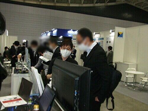 ブース来場者へ説明している様子1